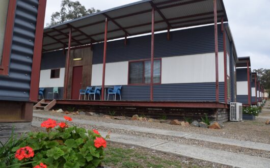 Two Bedroom Villa with its long verandah and red geraniums out the front