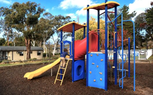 Playground with slides, climbing frames and a climbing wall, under the gums