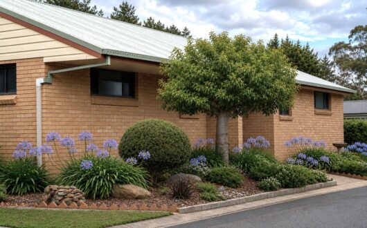 Brick amenities block with agapanthus and gardens along the front