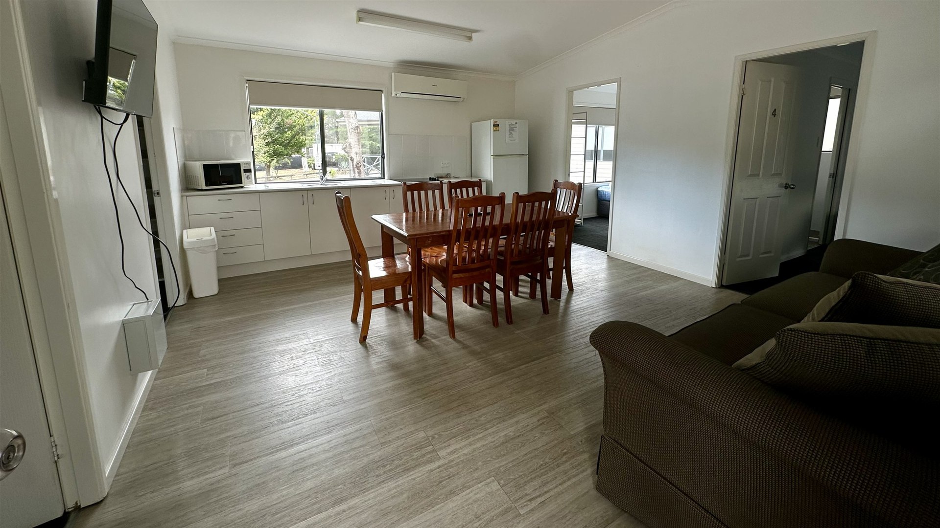 Family Bungalow living and dining area with a table for six and a sofa
