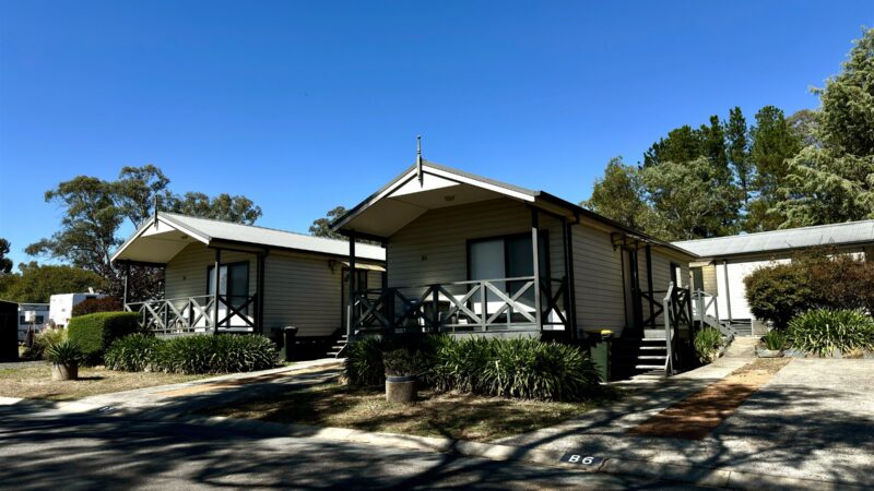 Bungalow exterior with its own verandah and steps, under a clear blue sky