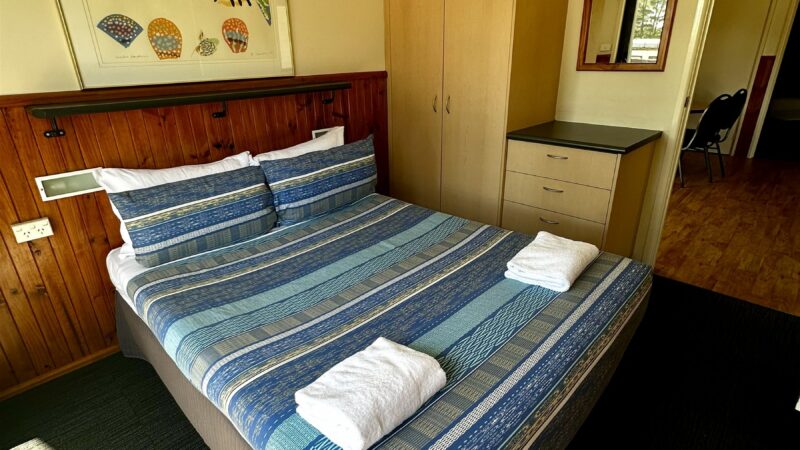 Bungalow bedroom with a double bed made up and towels laid out