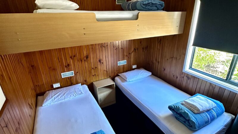 Bungalow twin room with two single beds and timber lined walls