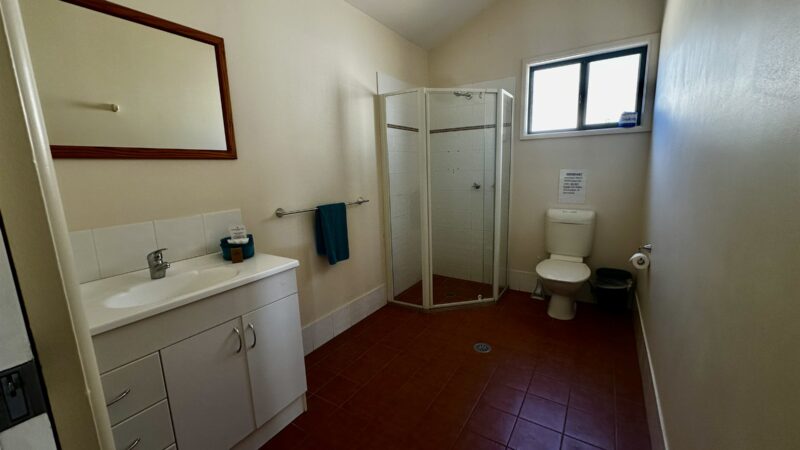 Bungalow bathroom with vanity, mirror, shower and toilet