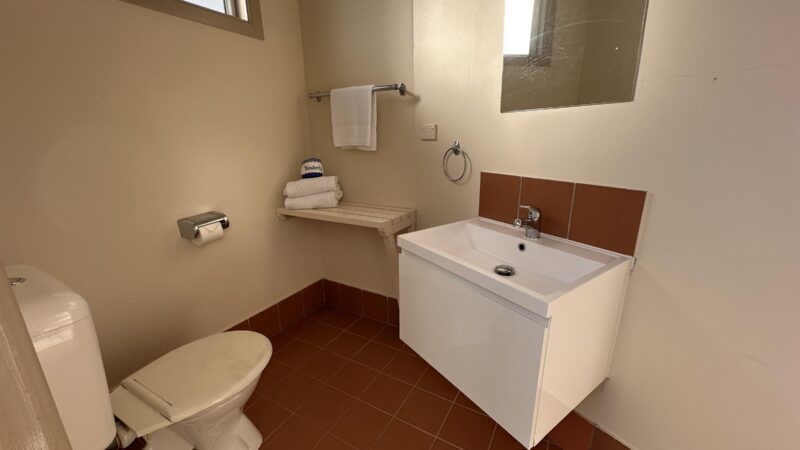 Inside a site ensuite, with toilet, basin and towel rail