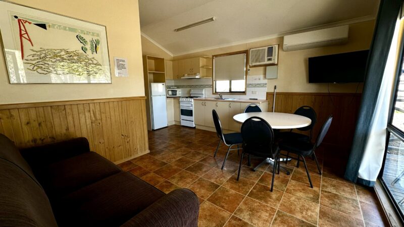Large bungalow living and dining area with the kitchen at the far end