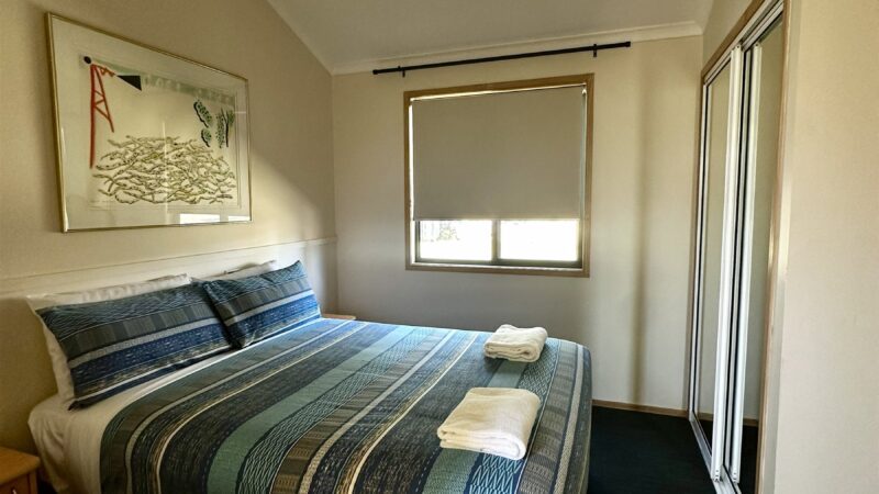 Large bungalow main bedroom with a double bed and ceiling fan