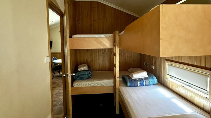Bunk room in the large bungalow, timber lined with a window above