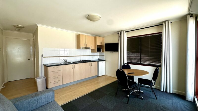 One Bedroom Villa living area with a kitchenette, desk and sofa